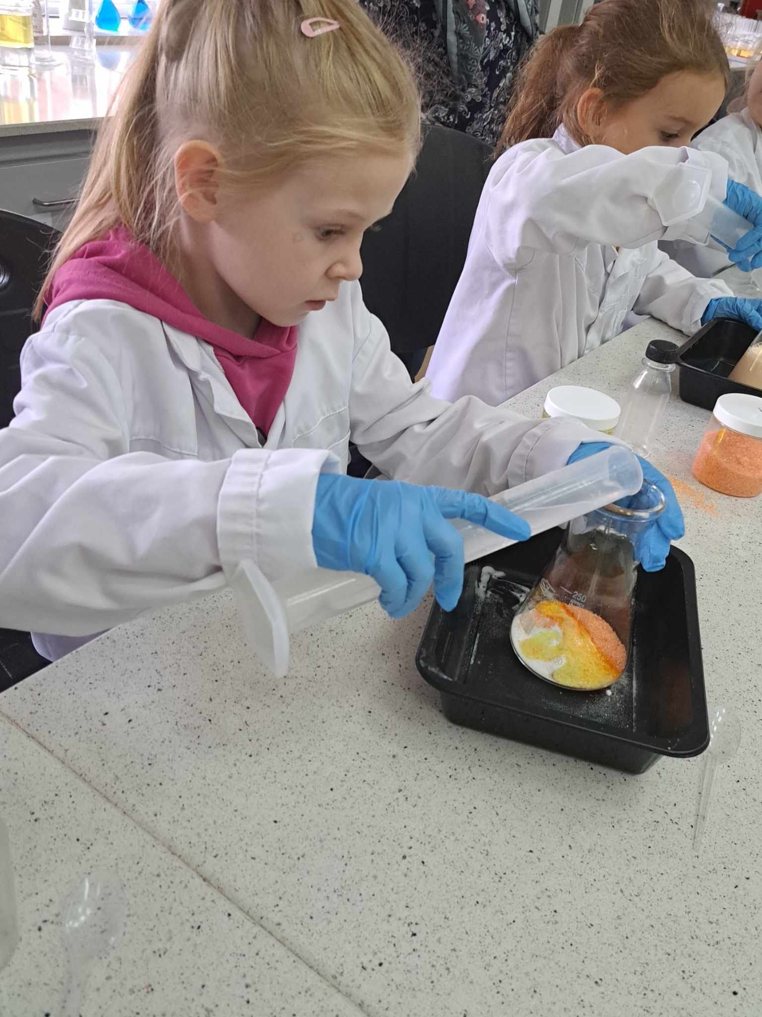 Dzieci w sali wykonują eksperymenty